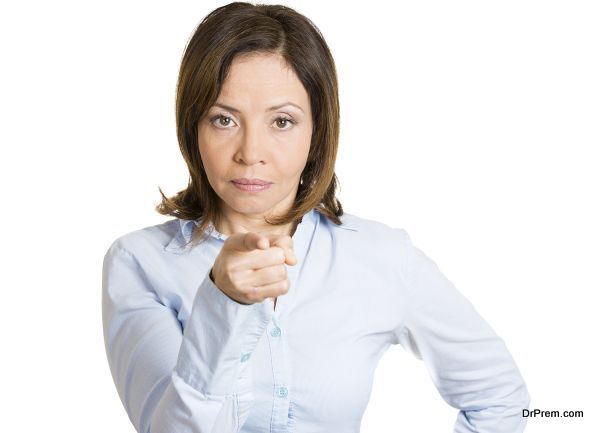 Closeup portrait, young pretty unhappy, serious woman pointing at someone as if to say you did something wrong, bad mistake isolated white background. Negative emotion, facial expression feeling