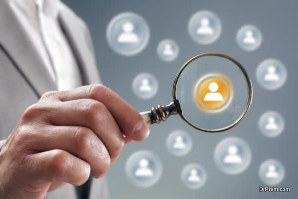 Businessman with magnifying glass on team personnel or contact icon concept for recruitment, social media, network, community and  internet marketing