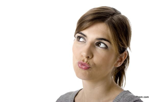 Close-up portrait of a beautiful young woman thinking in something good - isolated on white.