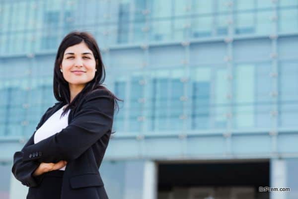 Smiling bussinesswoman with copyspace in front of a building