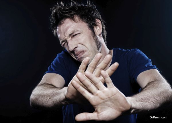 studio portrait on black background of a funny expressive caucasian man pucker stop rejection