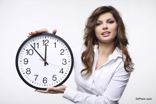 Beautiful smiling woman holding big clock.