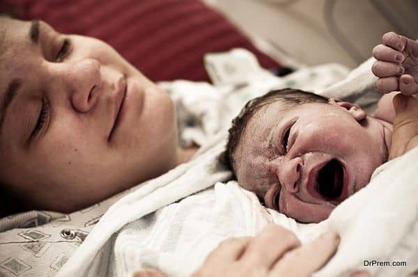 Mother Holding Newborn At The Hospital