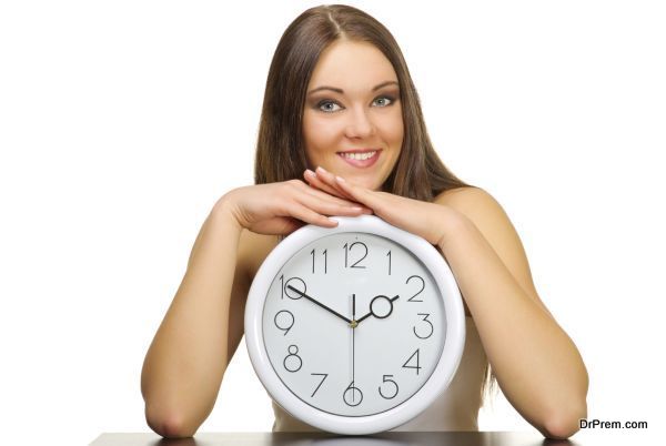 Young girl with clock isolated