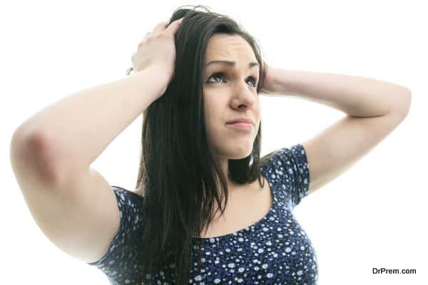 Hysterical woman expression with her hands on the head on a white isolated background