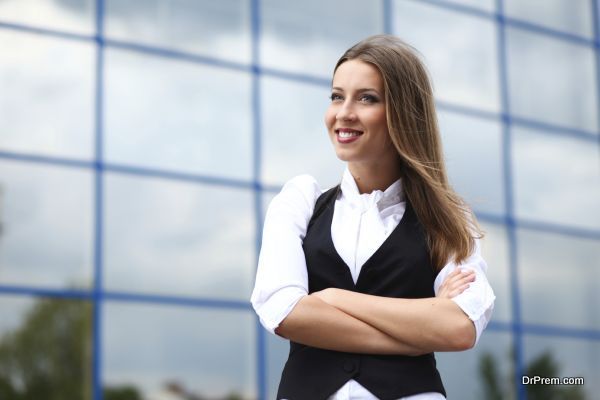 Young success businesswoman standing near office building