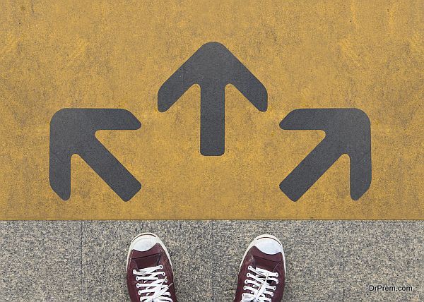 Pair of shoes standing on a road with three grey arrow on the yellow background