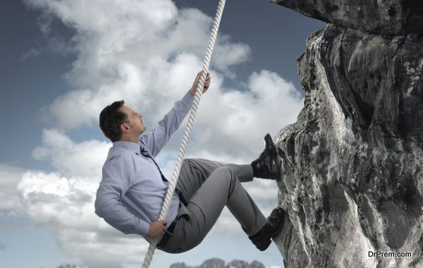 Businessman climbing mountain