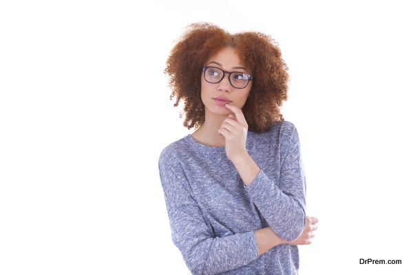 Young african american teenage girl looking up, isolated on white background