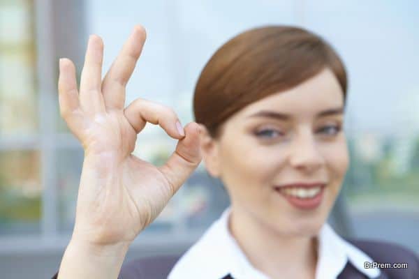 Businesswoman shows ok sing.