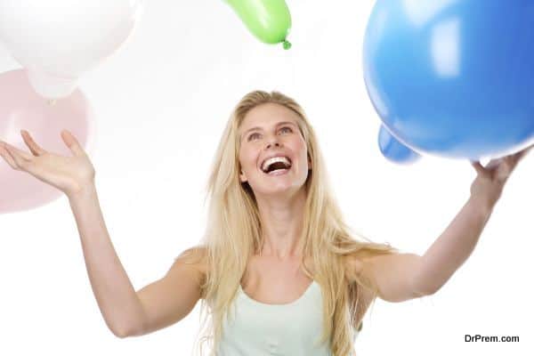 Beautiful young woman smiling with balloons