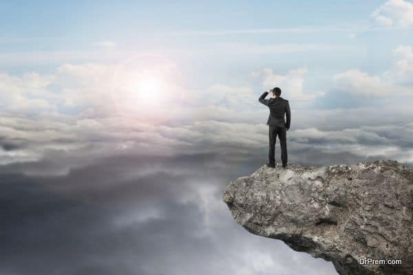 businessman looking on cliff with natural sky daylight cloudscape