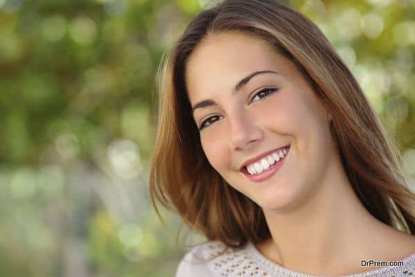 Beautiful white woman smile dental care concept with a green background