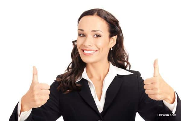 Businesswoman with thumbs up, on white