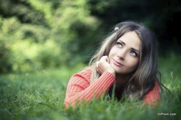 Summer. Portrait of pretty asiatic girl dreaming at meadow