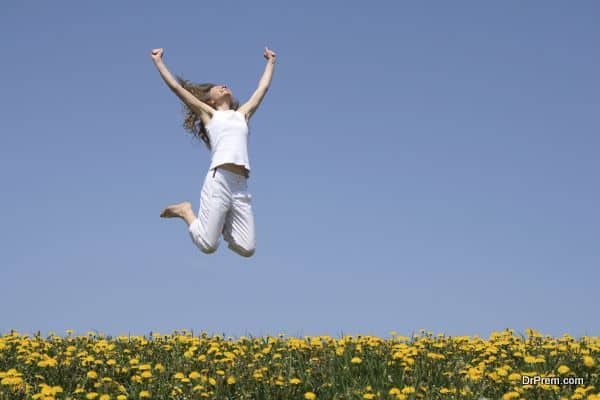 Smiling young woman in a happy jump