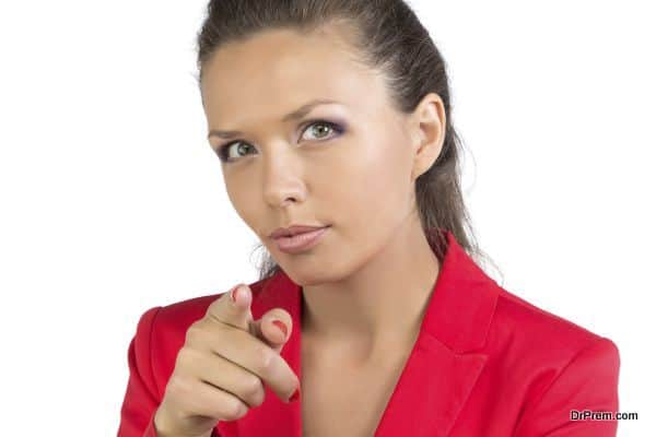 Businesswoman pointing forefinger at camera