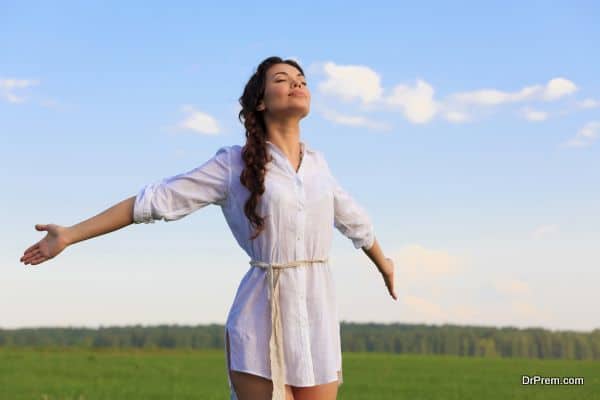 Young happy woman in green field