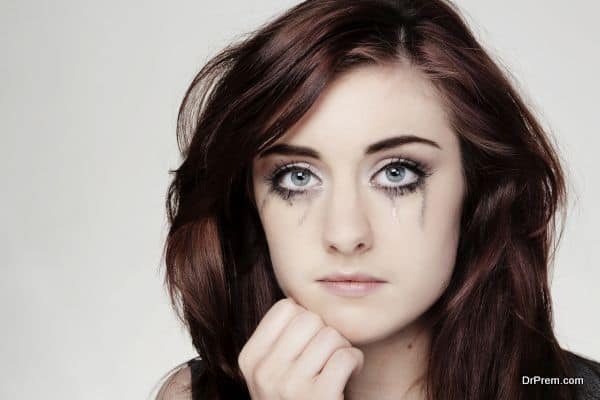 close up portrait of a young woman crying make up running down face