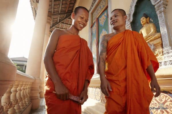 Two monks meet and salute in a buddhist monastery, Asia