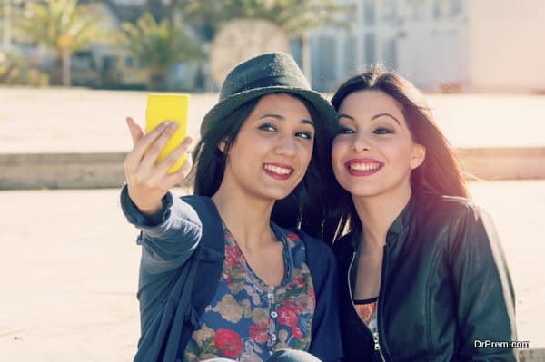 two friends taking selfie with a filter applied instagram style