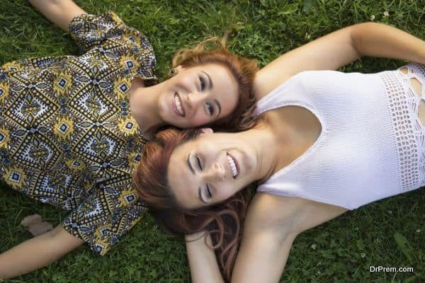 Shot from above, two happy girls having fun time, smiling.