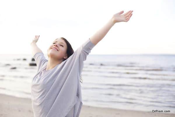 Happy Woman Stretching Her Arms to Enjoy Nature