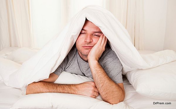 man in bed suffering insomnia and sleeping disorder
