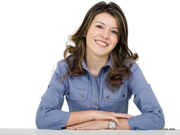 beautiful young business woman portrait - smiling over a white background
