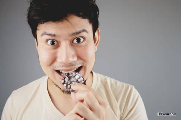 Man eats cookies.