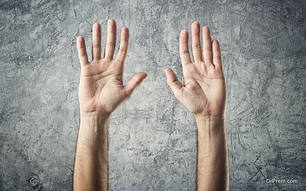 Caucasian male open hands raised as surrender gesture on grunge background