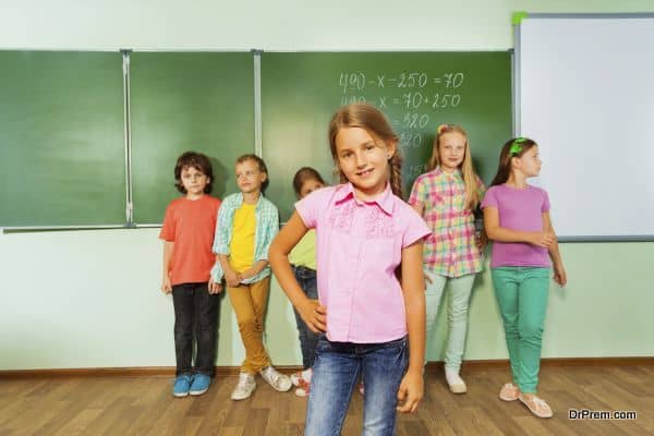 Girl stands near blackboard with numbers