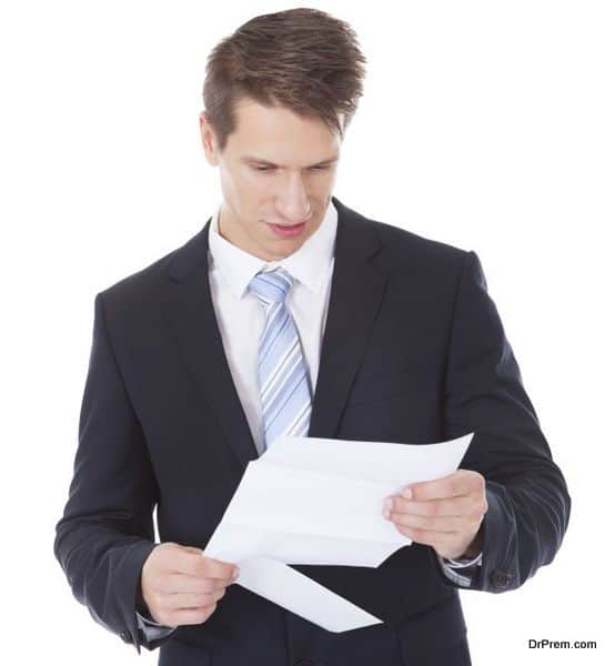 Serious Businessman Reading Document