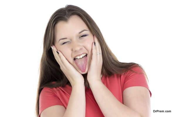 Photo of teenage girl showing tongue