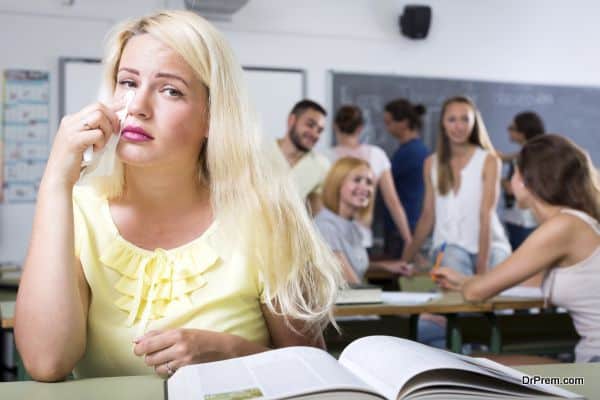 Blonde crying over a textbook