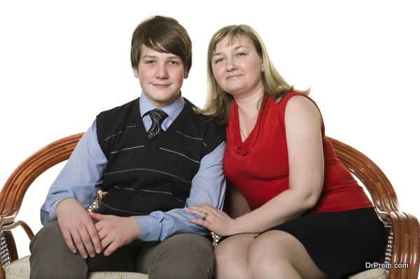 Young mother and teenage son on sofa