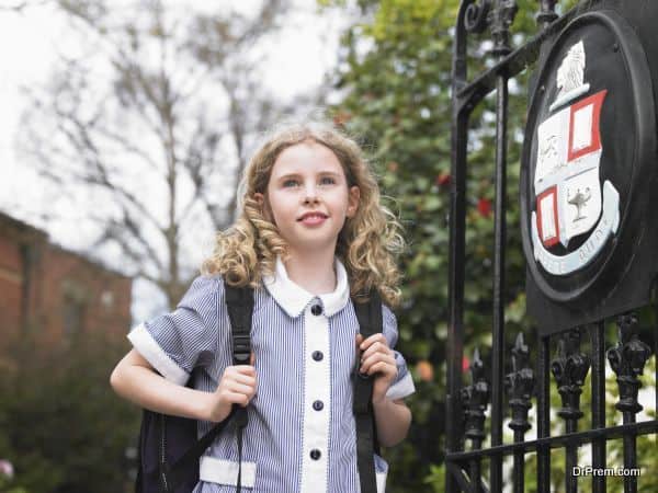 Girl Standing By School Gate