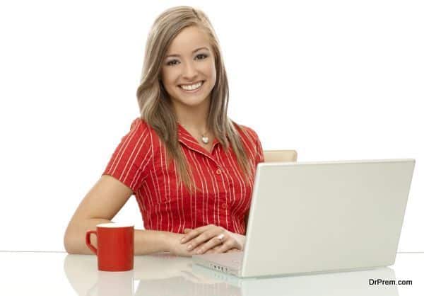 Portrait of happy woman with laptop