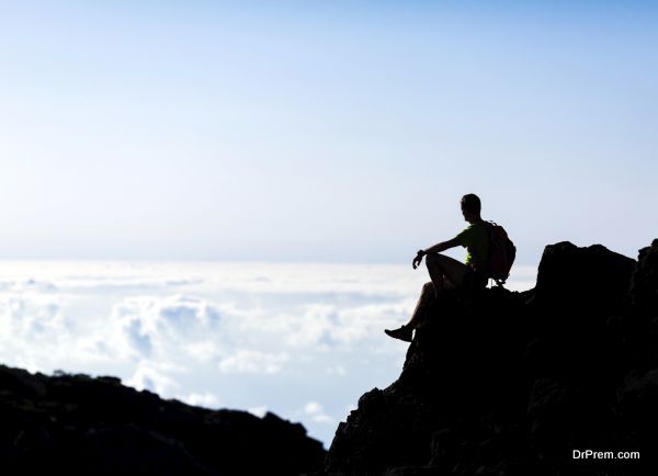 Hiking silhouette backpacker, man trail runner in mountains