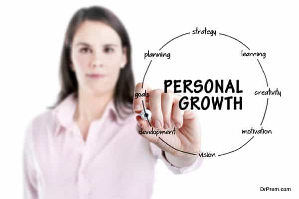 Young businesswoman holding a marker and drawing circular structure.