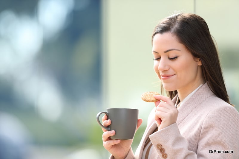 Entrepreneur eating cookie and drinking coffee