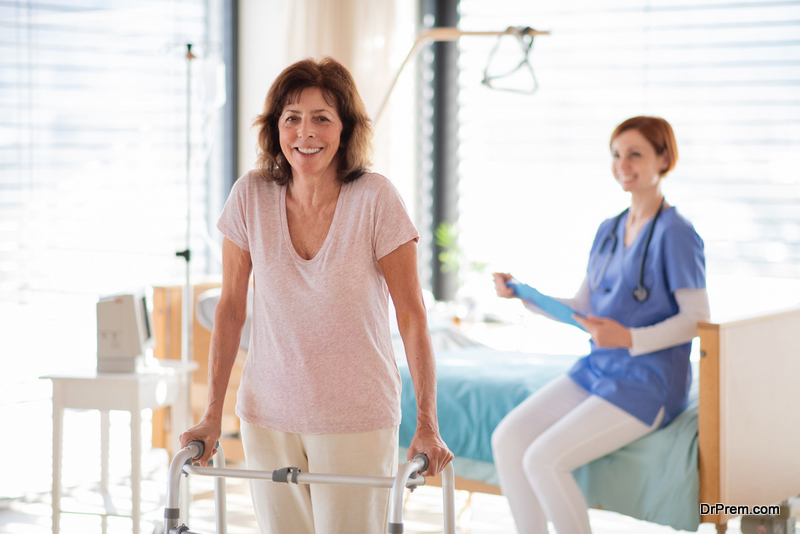 A senior woman patient with walking frame in hospital room