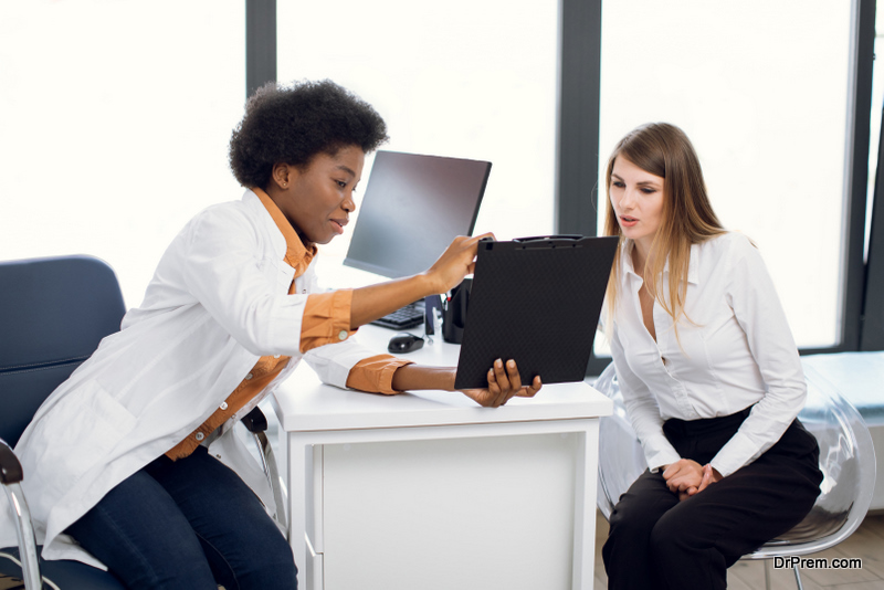 African American female doctor and pretty Caucasian woman patient 