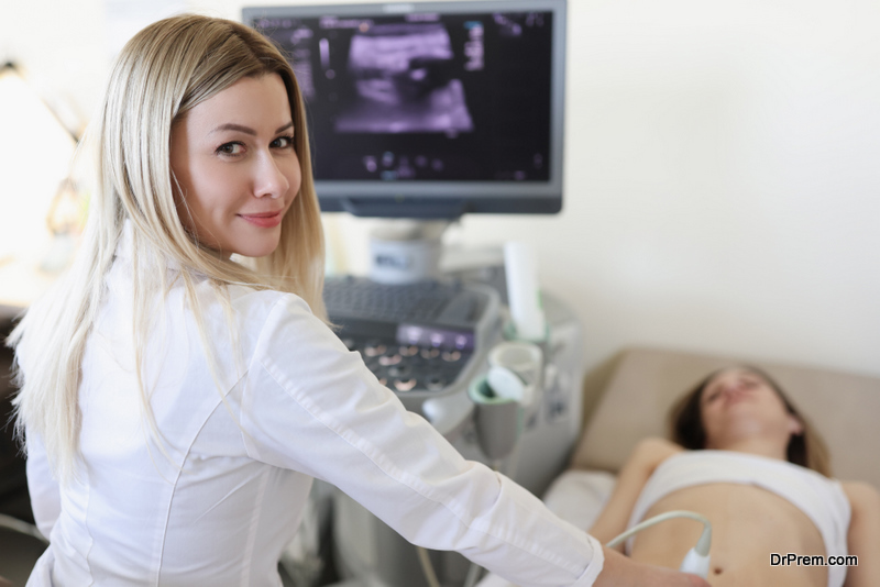 Doctor doing ultrasound scan to woman patient in clinic