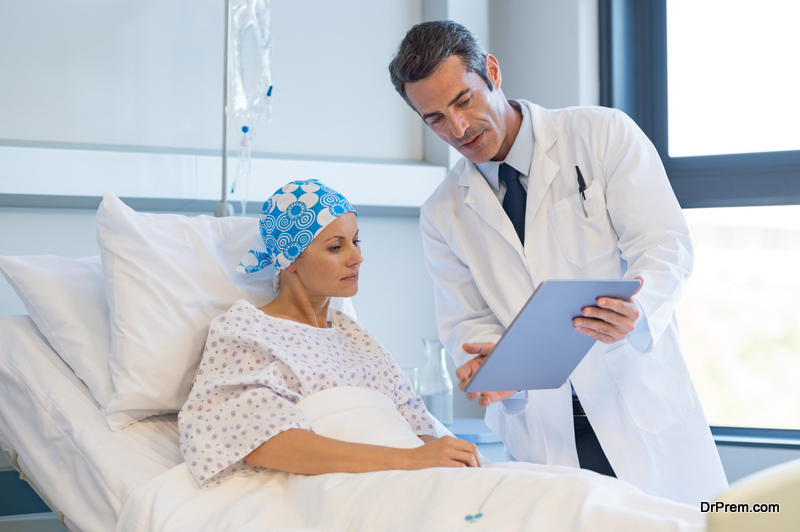 Doctor showing medical records to cancer patient in hospital ward