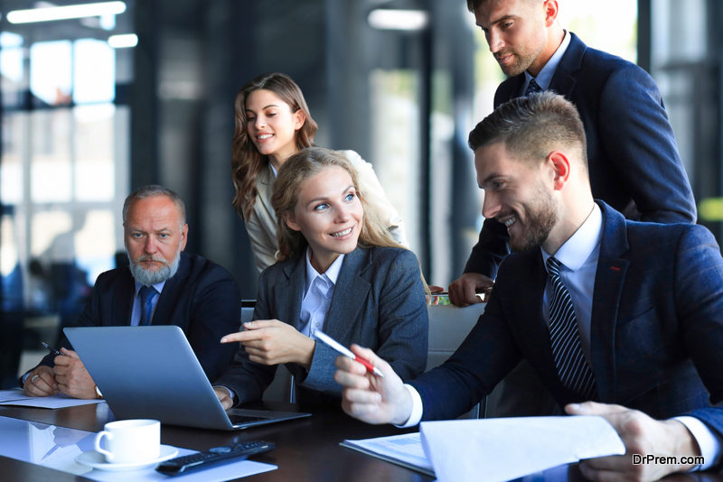 Group of business partners discussing ideas and planning work in office