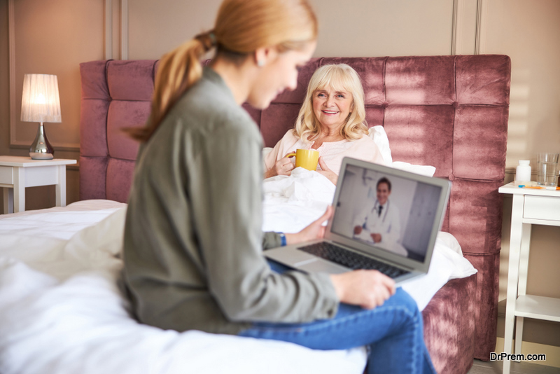 Happy woman having consultation with doctor online at home