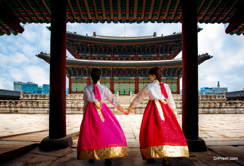 Korean lady in Hanbok or Korea gress and walk in an ancient town and Gyeongbokgung Palace in seoul