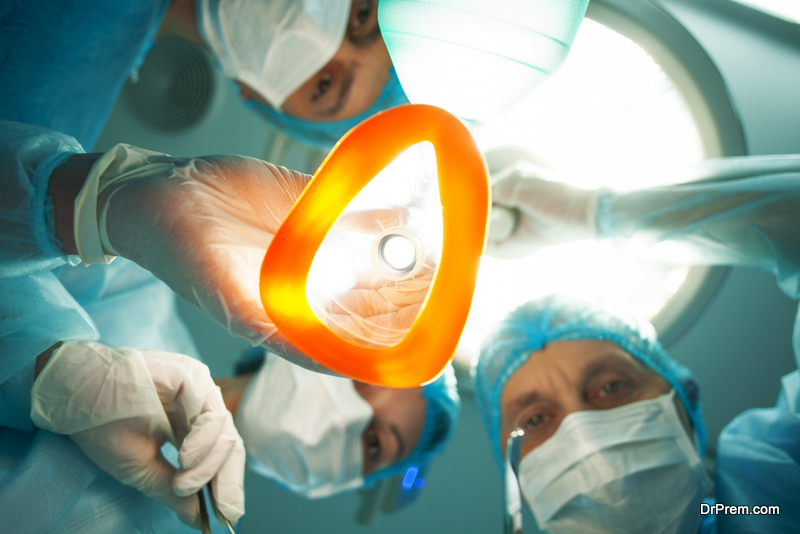  Low angle of professional surgeons giving to patient a general anesthetic before an operation