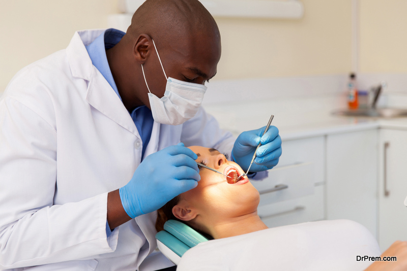 Male dentist examining womans teeth